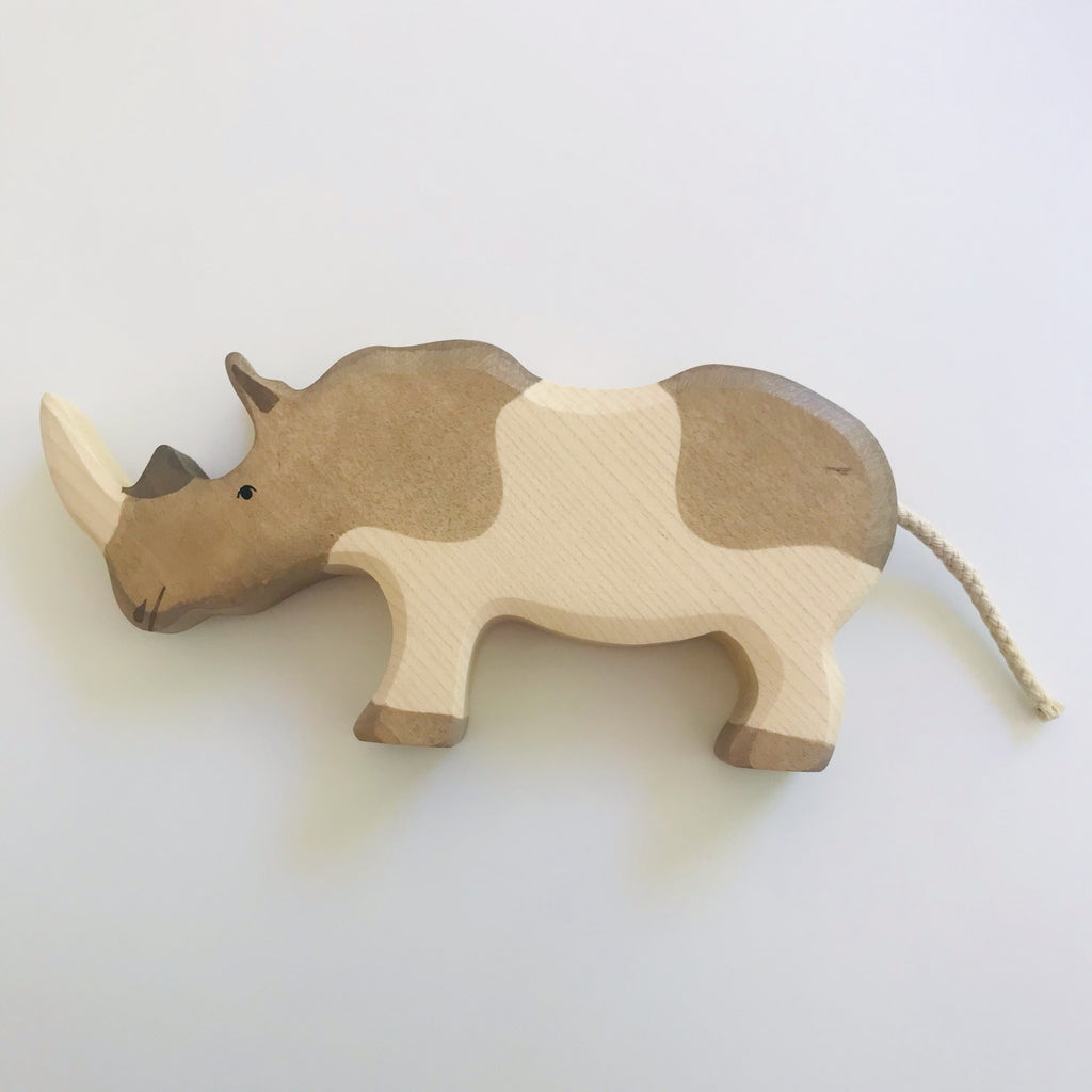 hand made wooden toy rhino. Hand painted features and a rope tail