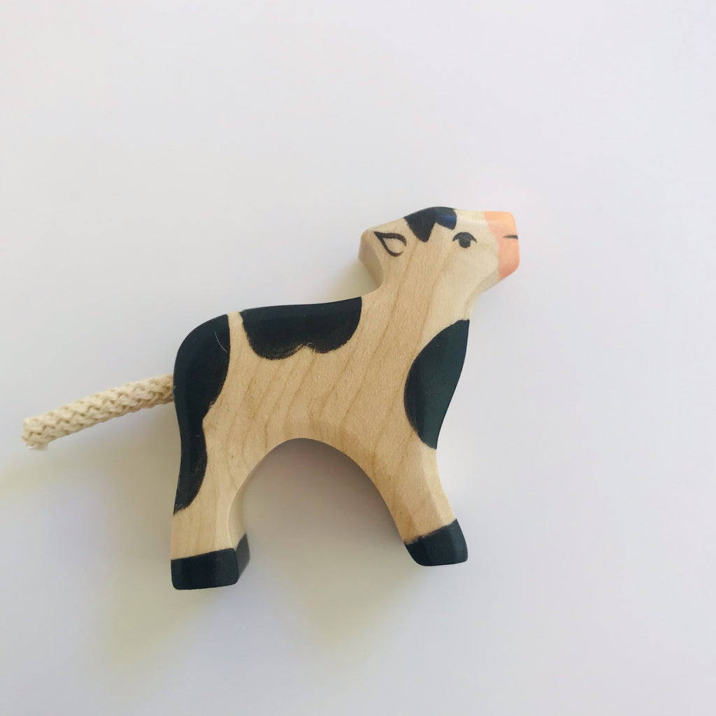 hand made wooden calf with black detailing and facial features