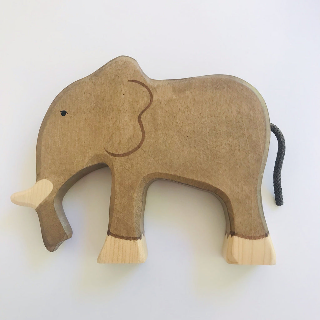 hand made wood elephant with rope tail. Hand painted features